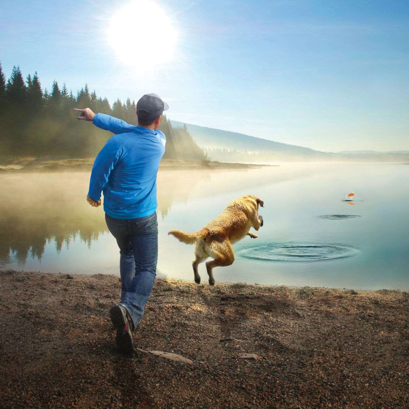 Man throwing a skipping stone into a clam lake for his dog to fetch.